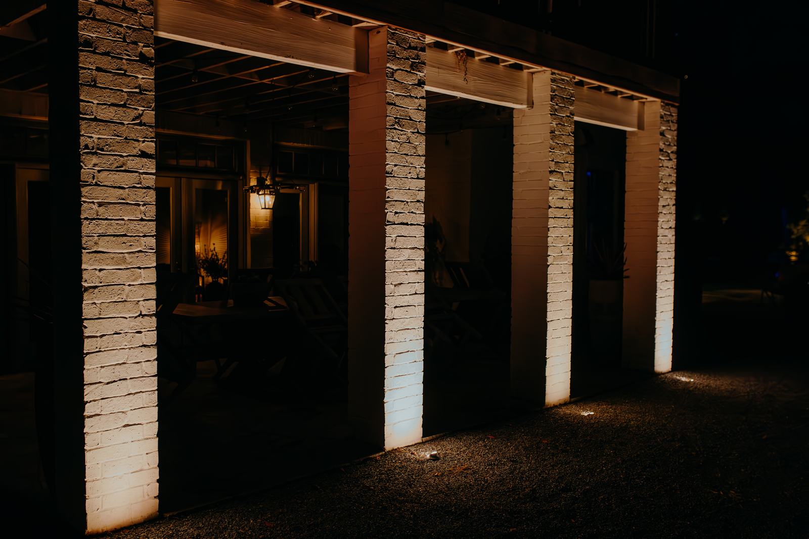 Brick porch columns lit at night